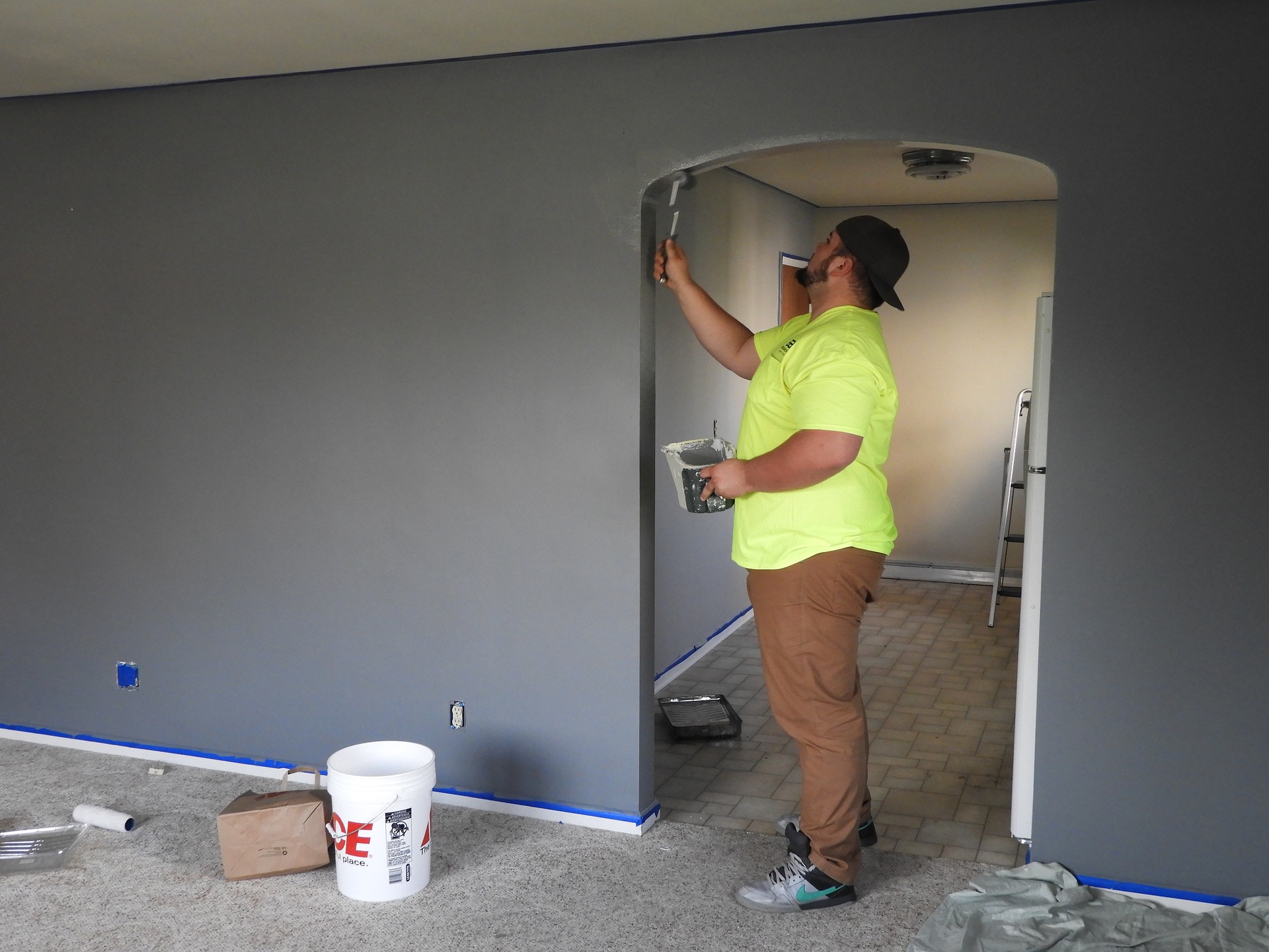 A man paints a home to fix and flip