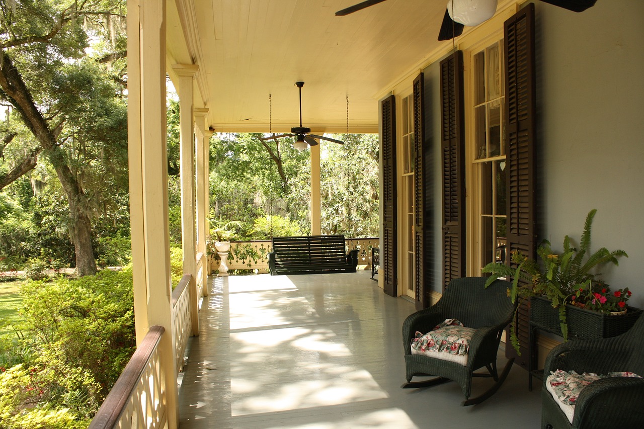 The side of a lovely house, featuring an attractive porch.